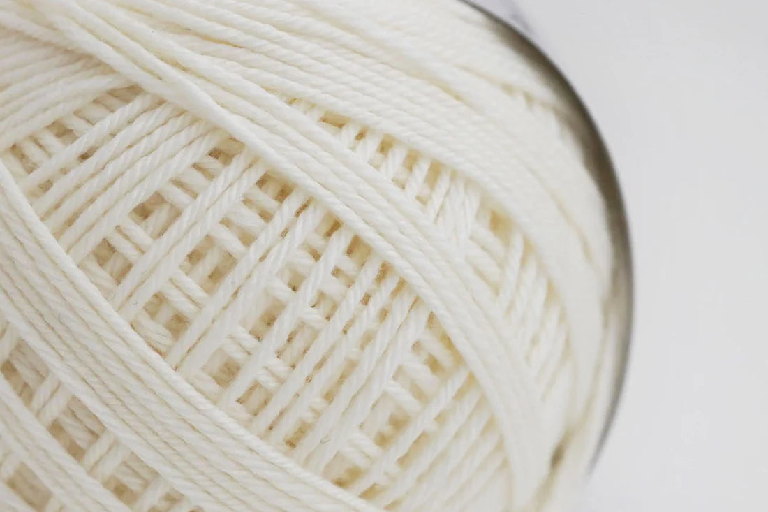 A luxury white yarn blending Rambouillet merino wool with Supima cotton, bringing an exquisite balance of smooth cotton and a light touch of wool.