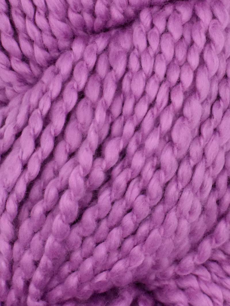Close-up of chunky-knit Juniper Moon Farm Bud yarn texture in orchid purple, 100% GOTS certified organic Peruvian cotton.