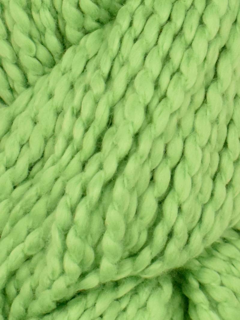 Close-up of chunky-knit Juniper Moon Farm Bud yarn texture in green, 100% GOTS certified organic Peruvian cotton.